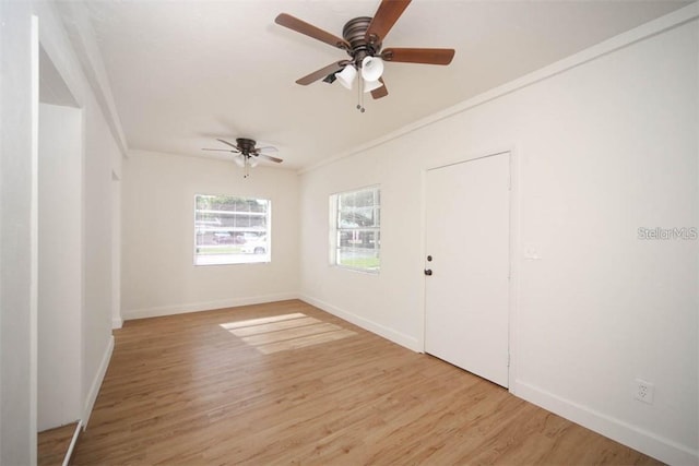 spare room featuring crown molding, ceiling fan, and light hardwood / wood-style flooring