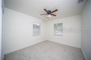 carpeted empty room featuring ceiling fan