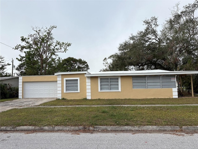 view of front of home with a front lawn and a garage