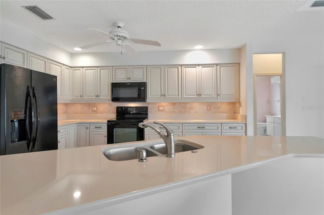 kitchen featuring white cabinetry, sink, ceiling fan, and black appliances