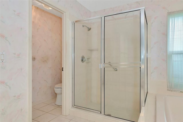 bathroom with an enclosed shower, toilet, and tile patterned floors