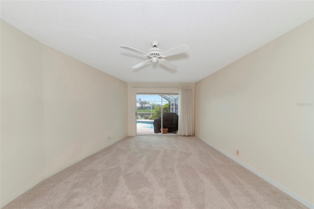 unfurnished living room with light carpet, a textured ceiling, and ceiling fan