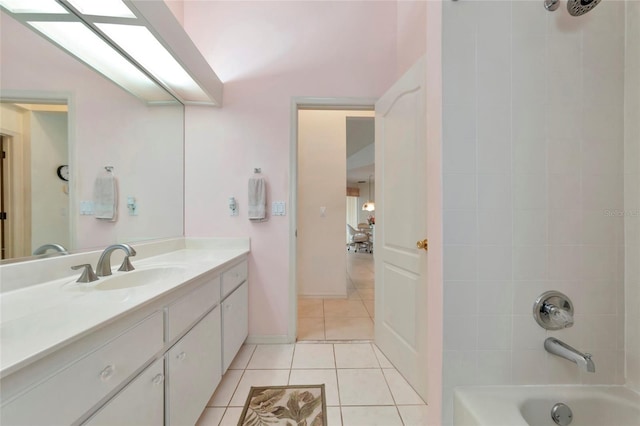 bathroom featuring tile patterned flooring, vanity, and tiled shower / bath