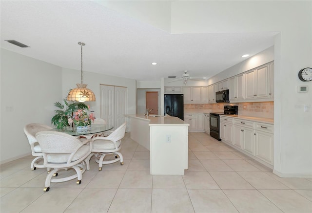 kitchen featuring black appliances, white cabinets, ceiling fan, tasteful backsplash, and decorative light fixtures