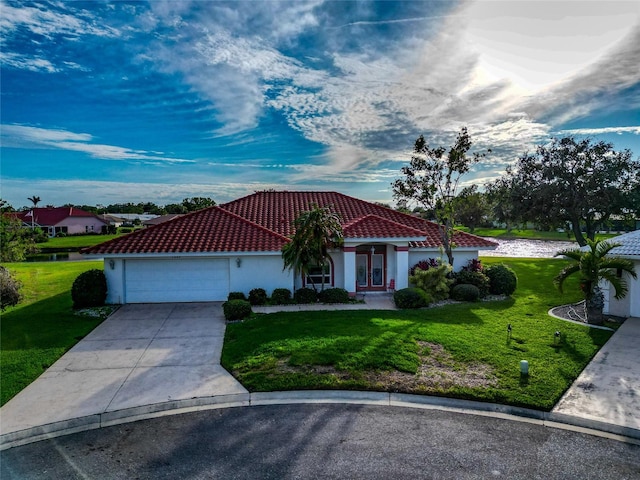 view of front of property featuring a water view, a front lawn, and a garage