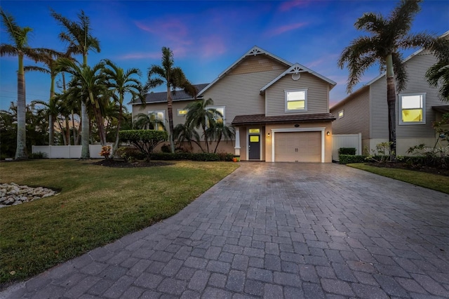 view of front facade with a yard and a garage