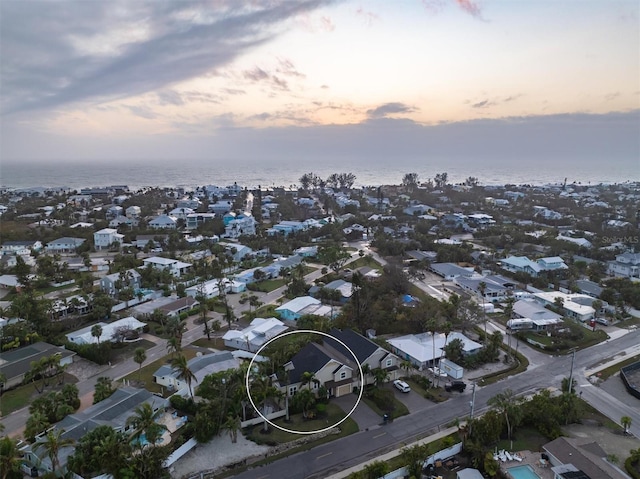 aerial view at dusk with a water view