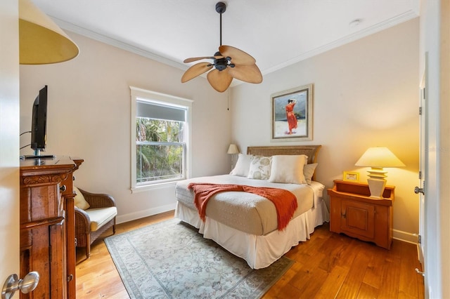 bedroom with wood-type flooring, ceiling fan, and ornamental molding