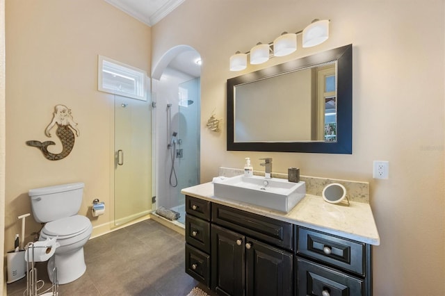 bathroom with toilet, a shower with door, vanity, and crown molding