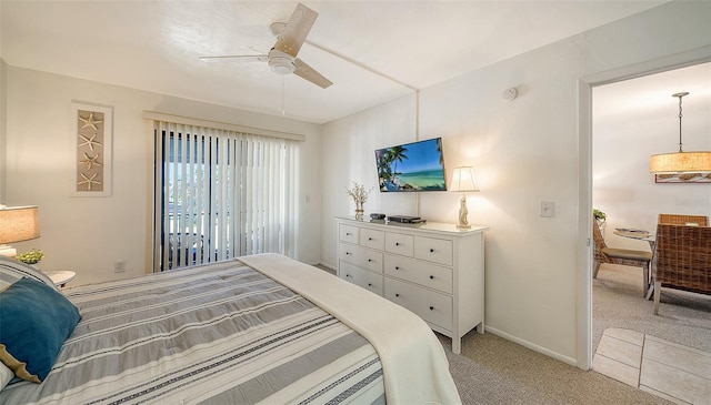 bedroom featuring light colored carpet and ceiling fan