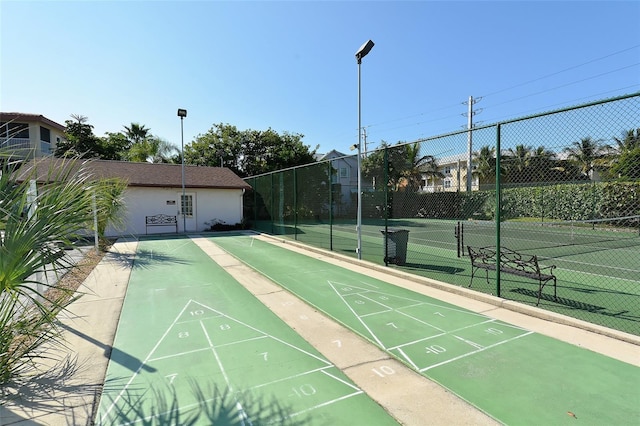 surrounding community with tennis court