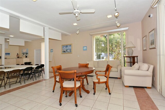 dining space with ceiling fan, track lighting, and light tile patterned floors