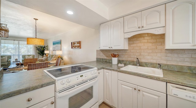 kitchen featuring sink, white appliances, white cabinetry, hanging light fixtures, and tasteful backsplash