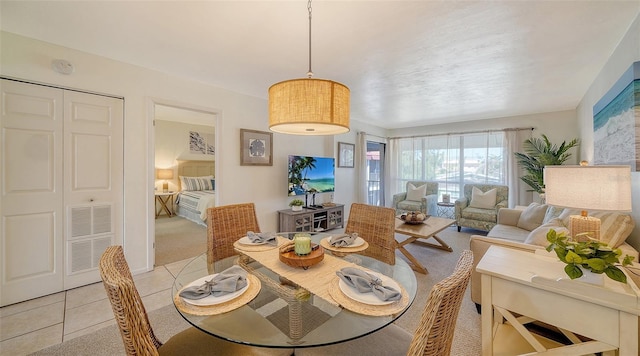 dining space featuring light tile patterned flooring