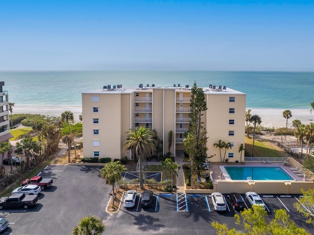 view of property featuring a water view and a beach view