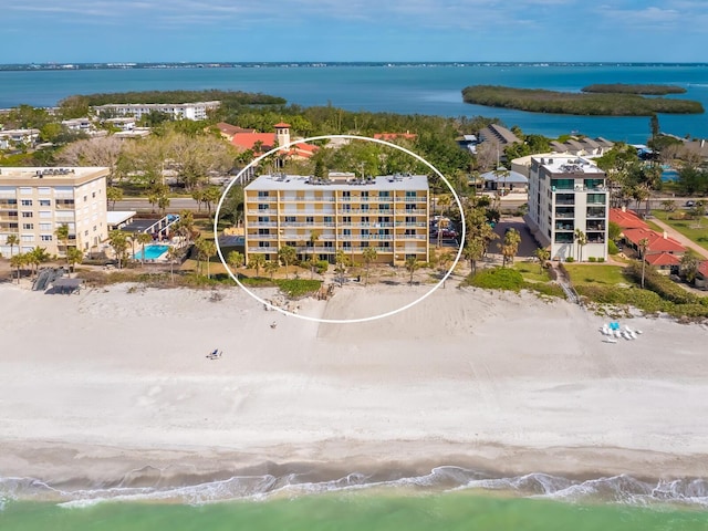 drone / aerial view featuring a water view and a beach view