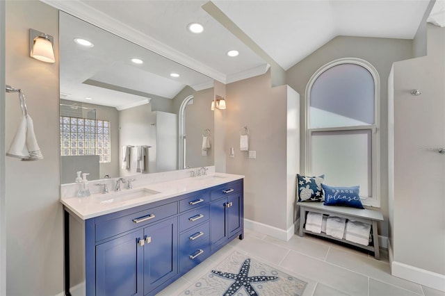 bathroom featuring tile patterned floors, vanity, lofted ceiling, and ornamental molding