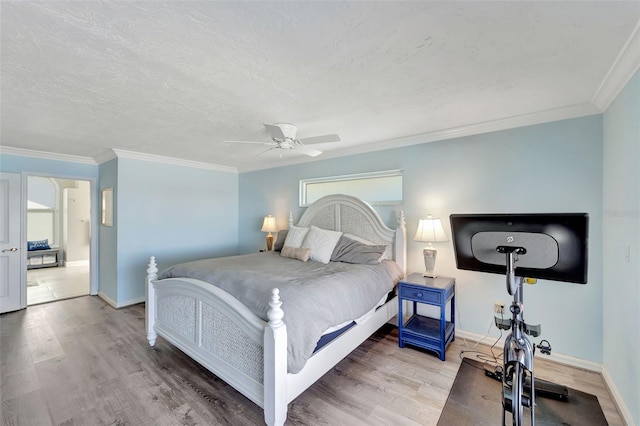 bedroom featuring ceiling fan, ornamental molding, and hardwood / wood-style flooring