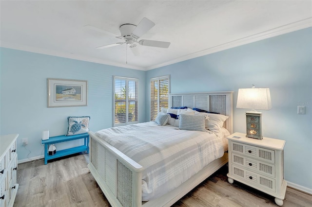 bedroom with light hardwood / wood-style flooring, ceiling fan, and crown molding