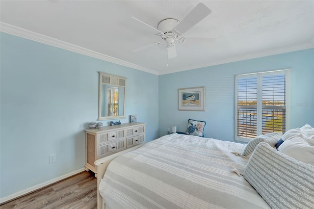 bedroom with light hardwood / wood-style flooring, ceiling fan, and ornamental molding