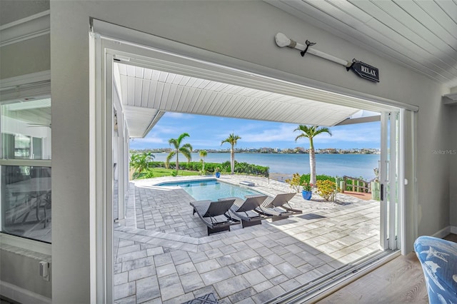 view of swimming pool with a water view