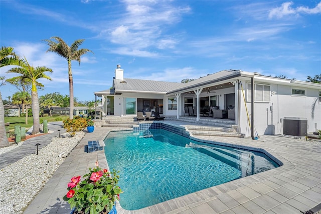 view of swimming pool with ceiling fan, central air condition unit, and a patio