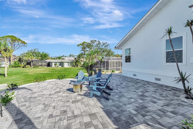 view of patio / terrace featuring a lanai and an outdoor fire pit