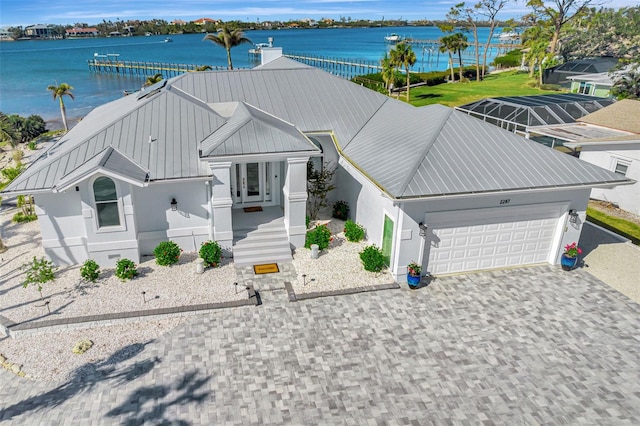 view of front of property with a water view and a garage