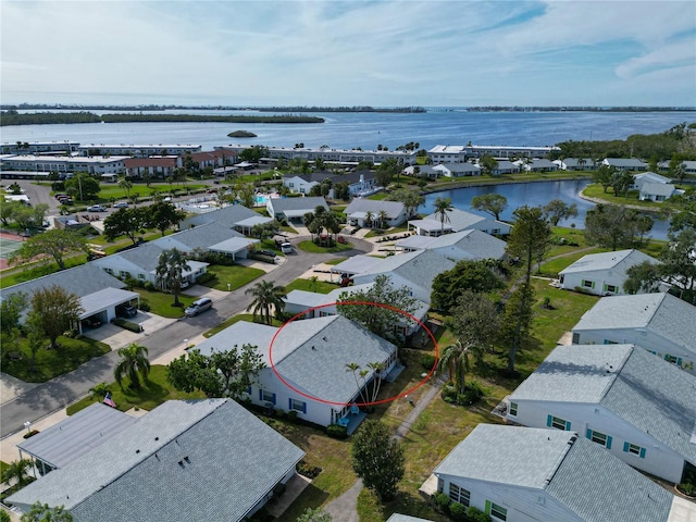 birds eye view of property featuring a water view and a residential view