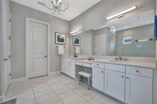 bathroom featuring tiled shower, vanity, and a notable chandelier