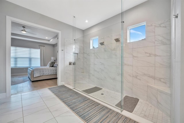 bathroom featuring a tile shower, ceiling fan, and plenty of natural light