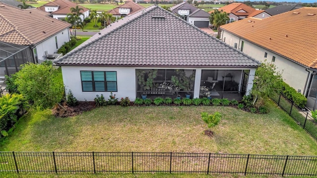 back of house with a lawn