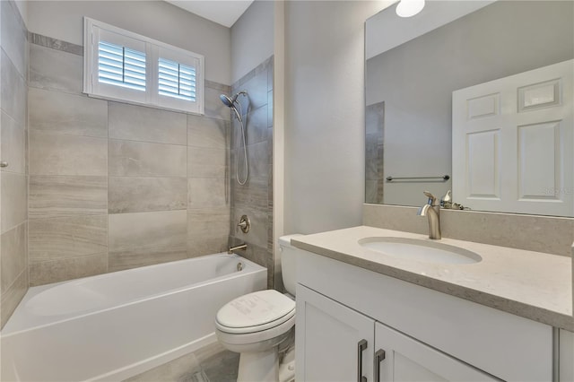 full bathroom featuring tile patterned floors, toilet, vanity, and tiled shower / bath