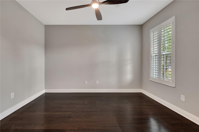 empty room featuring ceiling fan and dark wood-type flooring