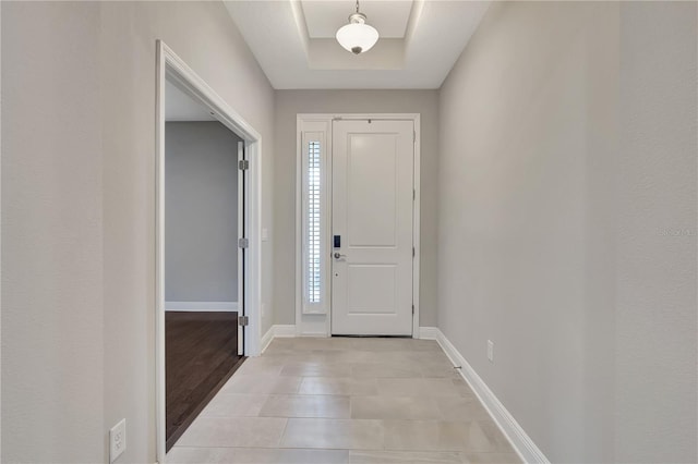 entrance foyer featuring a raised ceiling