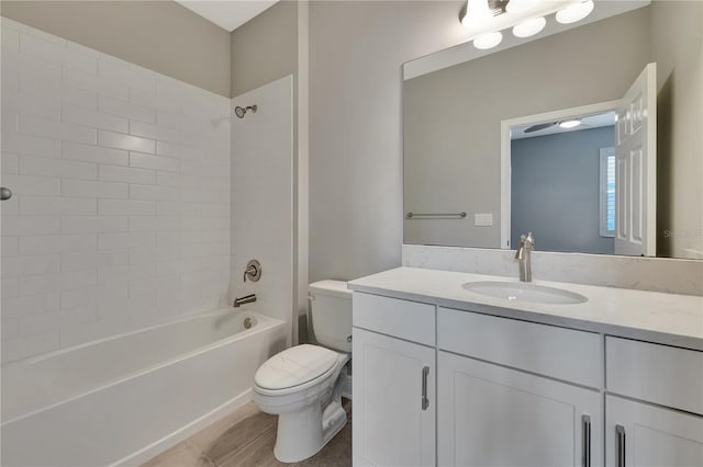 full bathroom with toilet, tiled shower / bath, tile patterned flooring, and vanity