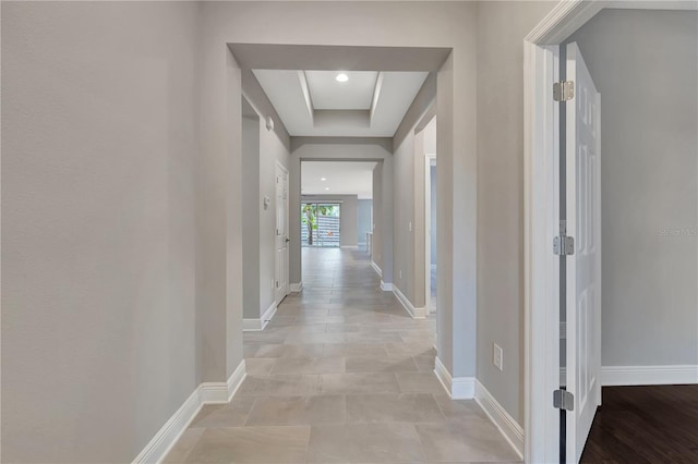 hall with a tray ceiling