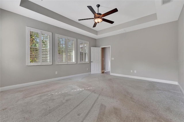 spare room featuring ceiling fan and a tray ceiling