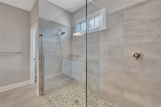 bathroom featuring tile patterned flooring and tiled shower