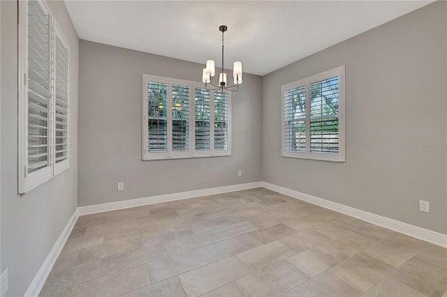 empty room featuring an inviting chandelier and light tile patterned flooring