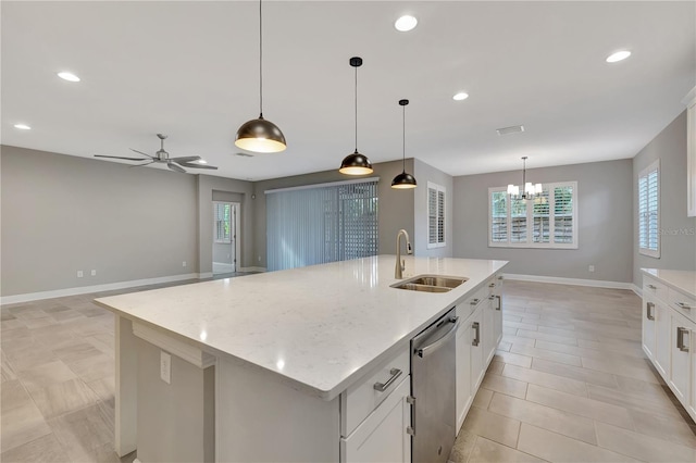 kitchen featuring decorative light fixtures, sink, dishwasher, and a kitchen island with sink