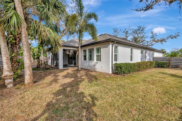 back of property featuring a lawn