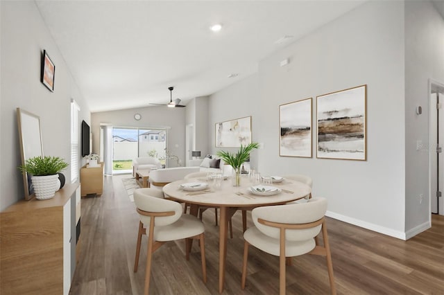 dining room with lofted ceiling, ceiling fan, and dark wood-type flooring