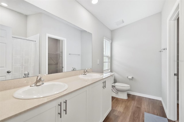 bathroom featuring hardwood / wood-style floors, vanity, toilet, and a shower with curtain