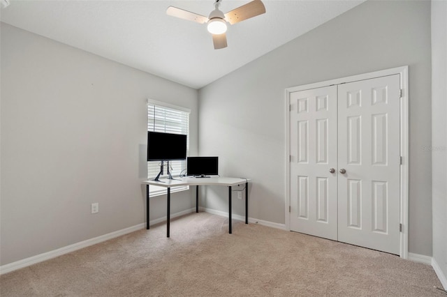 home office featuring ceiling fan, light colored carpet, and lofted ceiling