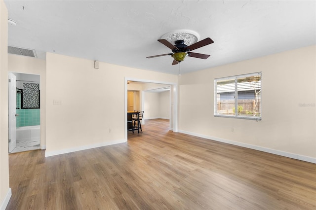 unfurnished room with ceiling fan and light wood-type flooring