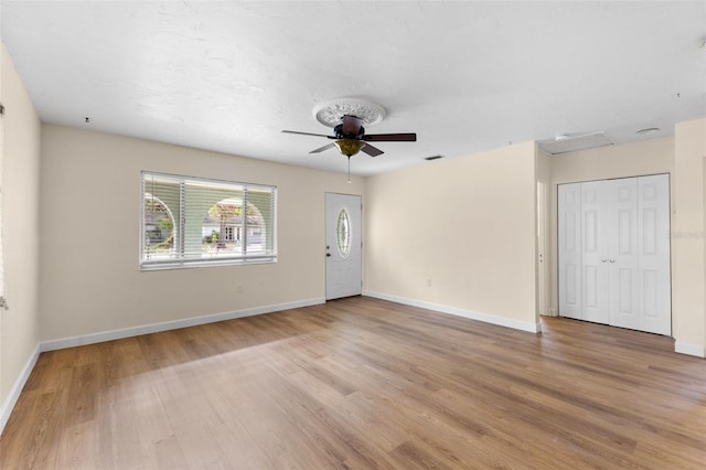 unfurnished living room with ceiling fan and light hardwood / wood-style floors