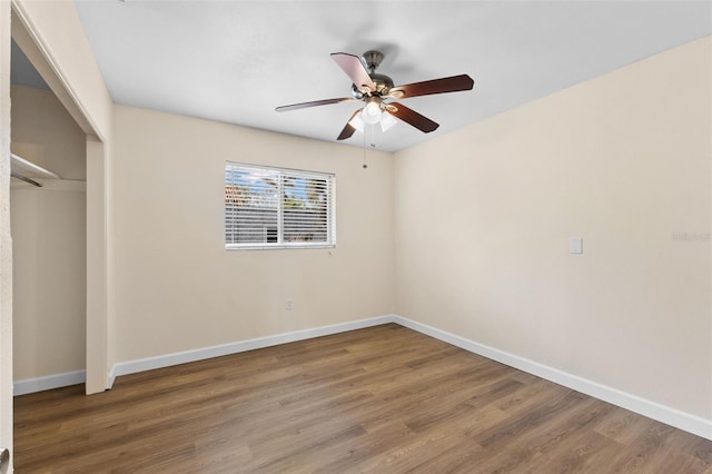 unfurnished bedroom featuring a closet, ceiling fan, and dark wood-type flooring