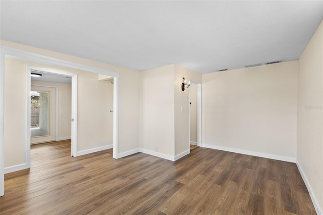 empty room featuring dark wood-type flooring