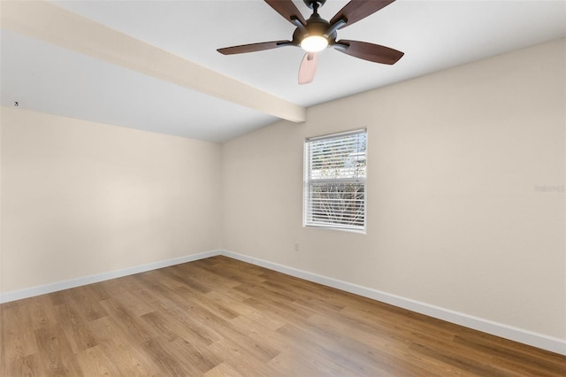 empty room with vaulted ceiling with beams, light hardwood / wood-style flooring, and ceiling fan